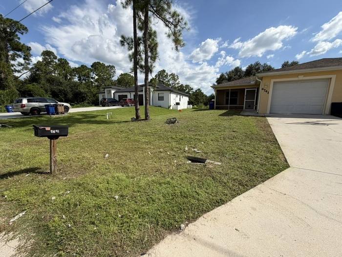Well maintained front yard with palm trees